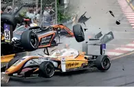  ?? AP ?? Teenage driver Sophia Floersch (top) goes over Japanese driver Sho Tsuboi’s car while flying off the track at high speed on a tight right-hand bend on lap four. —