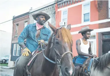  ??  ?? Idris Elba (left) and Caleb Mclaughlin play father and son in Concrete Cowboy. Images / Netflix via AP