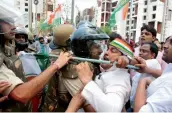  ?? — AFP ?? Police clash with Congress Party workers during a protest in Bhopal on Saturday.