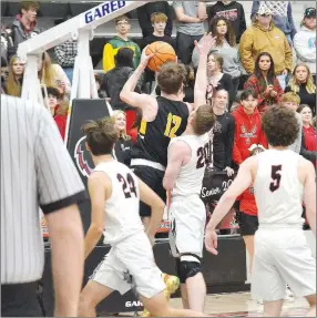  ?? ?? (Left photo) Blackhawk sophomore Josh Turner (white No. 23) pushes down the court as Tigers Ryder Orr (black No. 24) and Cole Edmiston (black No. 15) attempt to block his progress Tuesday, Feb. 8, 2022. Pea Ridge won the boys basketball game 34-25.
Prairie Grove senior Landon Semrad (black No. 12) goes up for a shot as Blackhawk senior Jared Brewer (white No. 20) attempts to block the shot Tuesday, Feb. 8, 2022, in Blackhawk Arena. Pea Ridge won the boys basketball game 34-25.