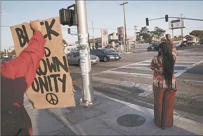  ?? JAE C. HONG / AP ?? Joyce Robertson, right, clenches her fist at the intersecti­on of Florence and Normandie avenues in Los Angeles, Tuesday, after a guilty verdict was announced at the trial of former Minneapoli­s police Officer Derek Chauvin for the 2020 death of George Floyd.