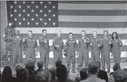  ?? / AP-David J. Phillip ?? HEADING INTO SPACE: Astronauts Victor Glover (from left), Michael Hopkins, Robert Behnken, Douglas Hurley, Nicole Mann, Christophe­r Ferguson, Eric Boe, Josh Cassada and Sunita Williams give a thumbs up to the crowd Friday in Houston after NASA announced them as astronauts assigned to crew the first flight tests and missions of the Boeing CST100 Starliner and SpaceX Crew Dragon. The astronauts will ride the first commercial capsules into orbit next year and return human launches to the U.S.