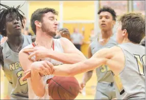  ?? RICK PECK/SPECIAL TO MCDONALD COUNTY PRESS ?? McDonald County’s Teddy Reedybacon fights for control of the ball as Neosho’s Mason Gammons (10) tries to swat it loose. Neosho’s Sam Cook and Landon Austin look on during the Wildcats’ 52-40 win on Jan. 31 at MCHS.