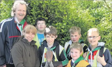  ?? Photos: Sheila Fitzgerald. ?? Aaron, Conor, Liam, Con, and Mathas, members of Kanturk Scouts, with Leader Ben McAuliffe, and Rosie Campbell of Animal Magic Rescue, Kilmallock, at the Love Your Land Event at the Secret Garden, Newmarket.