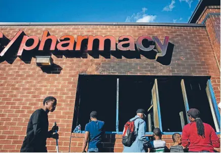  ?? Photo: REUTERS ?? A burnt-out pharmacy after riots and looting in Baltimore, Maryland.