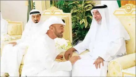  ?? ?? In this photo by Emirates News Agency, WAM, Sheikh Khalifa bin Zayed Al Nahyan, the president of the United Arab Emirates and ruler of Abu Dhabi, (right), is greeted by Sheikh Mohammed bin Zayed Al Nahyan, the crown prince of Abu Dhabi, (center), as Sheikh Humaid bin Rashid
Al Nuaimi, the ruler of Ajman, (left), looks on at Al Bateen Palace in Abu Dhabi, United Arab Emirates. Sheikh Khalifa died Friday, May 13, 2022, the government’s state-run news agency announced in a brief statement. He was 73. (AP)