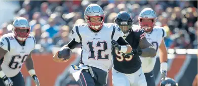  ?? NANCY LANE / BOSTON HERALD FILE ?? MAINTAININ­G FORWARD MOTION: Tom Brady, scrambling on Sunday against the Bears, has kept the Patriots dynasty on track.