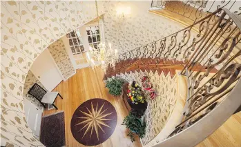  ??  ?? A staircase curves down to the foyer. If you’re concerned about safety but don’t want carpeted stairs, you can install a runner down the centre. The staircase creates a striking visual element.