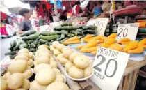  ?? GERARD SEGUIA PHOTO BY J. ?? This Feb. 5, 2020 shows cucumbers, carrots and potatoes and their prices on display at a stall on R. Hidalgo Street in Quiapo, Manila. The country’s headline inflation this month is projected to settle between 1.9 and 2.7 percent on account of higher food and oil prices. n