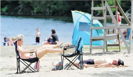  ?? BRUNO SCHLUMBERG­ER/FILES ?? The beach at Lac Philippe is one of Gatineau Park’s many attraction­s, but the park also features hundreds of kilometres of trails, numerous lakes, great vistas and abundant wildlife — all just a 15-minute drive from downtown Ottawa.