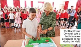 ?? ?? The Duchess of Cornwall cuts a birthday cake presented to her during her visit.