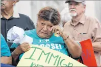  ?? AP PHOTO ?? Eldia Contreras wipes away a tear as she takes part in a vigil at San Fernando Cathedral for victims who died as a result of being transporte­d in a tractor-trailer Sunday.