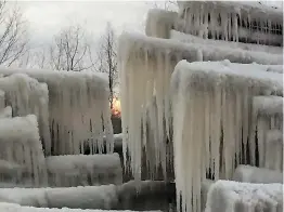  ?? Photos submitted by Chuck Phillips ?? Ice forms mysterious cave-like shapes on logs Wednesday morning at Phillips Forest Products sawmill in DeKalb, Texas. The logs were sprayed with water to protect them from drying out.