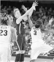  ?? STEPHEN M. DOWELL/STAFF PHOTOGRAPH­ER ?? UConn guard Katie Lou Samuelson (33) shoots between UCF players Lawriell Wilson (23) and Zakiya Saunders (3).