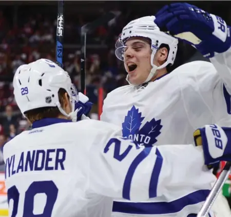 ?? SEAN KILPATRICK/THE CANADIAN PRESS ?? Auston Matthews, celebratin­g with teammate William Nylander, had his first NHL hat trick before his first NHL game was 22 minutes old.