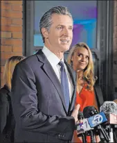  ?? The Associated Press Rich Pedroncell­i ?? California Gov. Gavin Newsom, accompanie­d by his wife, Jennifer Siebel Newsom, delievers remarks in Sacramento, Calif., after winning his second term in office Tuesday.