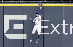  ?? AP ?? Los Angeles Dodgers right fielder Mookie Betts robs Atlanta’s Marcell Ozuna during the fifth inning of Game 6 of the National League Championsh­ip Series on Saturday in Arlington, Texas.