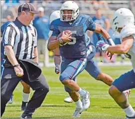  ?? SEAN D. ELLIOT/THE DAY ?? UConn quarterbac­k David Pindell (5) breaks through the line of scrimmage for a big gain during Saturday’s annual spring game at Rentschler Field in East Hartford.