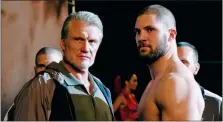  ?? BARRY WETCHER/ METRO GOLDWYN MAYER PICTURES/ WARNER BROS. PICTURES VIA AP ?? This image released by Metro Goldwyn Mayer Pictures / Warner Bros. Pictures shows Dolph Lundgren, left, and Florian Munteanu in a scene from "Creed II."