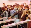  ?? — AFP ?? Passengers wearing face masks queue as they wait for the train to arrive at Jiujiang railway station in Jiujiang, a city which sits on the border between China’s central Jiangxi province and Hubei province, the epicentre of the country’s coronaviru­s outbreak, on Saturday.