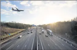  ??  ?? ■ A jet passes over the M1 at Kegworth. (Aaron Chown PA Wire)