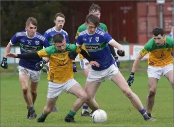  ??  ?? The ball goes to ground as Brian Moore (OLI/St. Fintan’s) battles with Cormac Rowe (Glynn-Barntown).