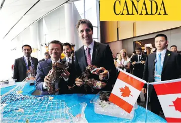  ?? MAPLE LEAF STRATEGIES ?? Prime Minister Justin Trudeau and Alibaba Group founder Jack Ma hold Clearwater lobster in Hangzhou, China, last year. The Liberal government announced that it will “enhance access” to the surf clam fishery for Indigenous groups, which means that...