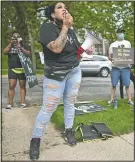  ?? (Star Tribune/Aaron Lavinsky) ?? Ashley Quinones, widow of Brian Quinones who was killed by Edina and Richfield police in 2019, protests outside Hennepin County Attorney Mike Freeman’s home in Minneapoli­s on May 27.