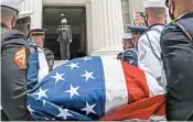  ?? JULIE BENNETT/AP ?? With a hand over her heart, Gov. Kay Ivey watches as Lewis’ casket is brought into the state Capitol in Montgomery.