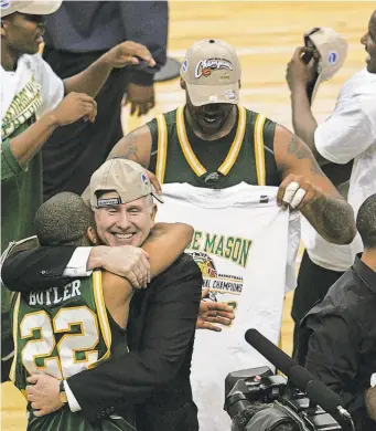  ?? SEAN DOUGHERTY/USA TODAY ?? Coach Jim Larranaga hugs Lamar Butler after George Mason defeated UConn to reach the 2006 Final Four.