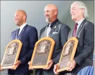  ?? Jim McIsaac / Getty Images ?? Derek Jeter, Larry Walker and Ted Simmons pose for a photograph with their plaques during the Baseball Hall of Fame induction ceremony at Clark Sports Center on Wednesday in Cooperstow­n, N.Y.