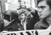  ?? Kevin Hagen / Associated Press ?? Protesters march in Times Square, one of more than 70 demonstrat­ions across the U.S. on Saturday.