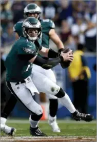  ?? KELVIN KUO — THE ASSOCIATED PRESS ?? Eagles quarterbac­k Carson Wentz scrambles for yardage against the Rams Sunday in Los Angeles.