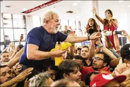  ?? RODRIGO CAPOTE / BLOOMBERG ?? Luiz Inacio Lula da Silva, Brazil’s former president, is carried on the shoulders of supporters Saturday, when he announced he will turn himself in to authoritie­s to begin serving a 12-year corruption sentence.