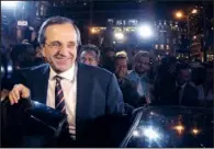  ?? AP/PETROS KARADJIAS ?? Antonis Samaras, leader of the New Democracy conservati­ve party in Greece, leaves an elections kiosk after speaking to supporters at Syntagma Square in Athens on Sunday.