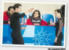  ?? THE CANADIAN PRESS ?? Coaches Patrice Lauzon and Marie-France Dubreuil talk with Scott Moir and Tessa Virtue during practice last week.