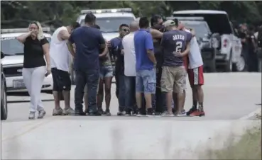  ?? ELIZABETH CONLEY — HOUSTON CHRONICLE VIA AP ?? Family members react as a van is pulled out of the Greens Bayou with the bodies of several family members on Wednesday in Houston. The van was carried into the bayou during Tropical Storm Harvey as the water went over the bridge.
