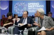  ?? THE ASSOCIATED PRESS ?? From left, Developmen­t Committee Chair and Indonesian Finance Minister Sri Mulyani Indrawati, World Bank President Jim Yong Kim, and Internatio­nal Monetary Fund (IMF) Managing Director Christine Lagarde confer before the Developmen­t Committee plenary...