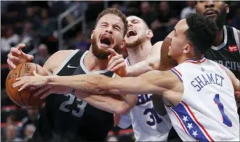  ?? PAUL SANCYA — THE ASSOCIATED PRESS ?? Detroit’s Blake Griffin (23) is fouled by the Sixers’ Mike Muscala (31) as Landry Shamet (1) reaches in Friday.