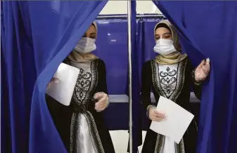  ?? Musa Sadulayev / Associated Press ?? Chechen women wearing traditiona­l dress leave a polling booth Sunday in Grozny, Russia. Few opposition candidates were even allowed to run after a sweeping crackdown on Kremlin critics.