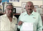  ??  ?? Chatsworth resident Morgan Naicker, left, with the assistance of councillor Ronnie Pillay, had his utility bill of R7 million cleared by the municipali­ty