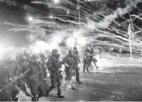  ?? NOAH BERGER/AP FILE ?? Police use chemical irritants and crowd control munitions to disperse protesters during a demonstrat­ion in Portland, Ore.