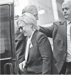 ?? BRENDAN SMIALOWSKI, AFP/GETTY IMAGES ?? Hillary Clinton gets in her car while leaving her daughter’s apartment building after resting on Sunday.