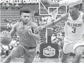  ??  ?? Florida State’s David Nichols drives on Javon Bess of Saint Louis during the first half Saturday in Sunrise.