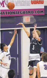  ?? GREG SORBER/JOURNAL ?? La Cueva’s Tyler Aeilts (3) takes a shot over the Monarchs’ James Sandoval during their game at Manzano on Tuesday night. Aeilts led the Bears in scoring with 18 points.