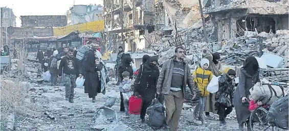  ?? AFP ?? Destrozos. Habitantes del este de la ciudad de Aleppo, en donde se refugiaban los rebeldes apoyados por EE.UU., abandonan la zona.