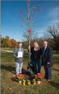  ?? SUBMITTED PHOTO ?? Neumann University in Aston planted a tree on campus on Nov. 7to honor former Aston Township Commission­er Carol Graham, who died on Jan. 12, 2021. The university is in the Second Ward, which Graham represente­d for 11 years. Pictured are Graham’s husband, James Graham; daughter, Kit Spayd; and Dr. Chris Domes, Neumann’s president.