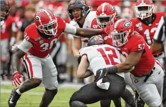  ?? BOB ANDRES / ROBERT.ANDRES@AJC.COM ?? Bulldogs defensive lineman Tyler Clark (52) sacks Arkansas State’s Logan Bonner with a little help from linebacker Tae Crowder.