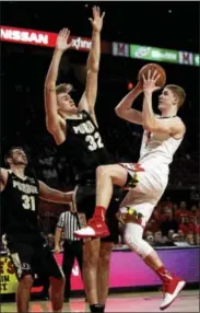  ?? PATRICK SEMANSKY - THE ASSOCIATED PRESS ?? Maryland guard Kevin Huerter, right, shoots against Purdue guard Dakota Mathias, left, and forward Matt Haarms, center, of the Netherland­s, in the second half of an NCAA college basketball game in College Park, Md., Friday, Dec. 1, 2017.