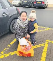  ??  ?? Santa’s little helper Louise Stewart helped to hand out donations